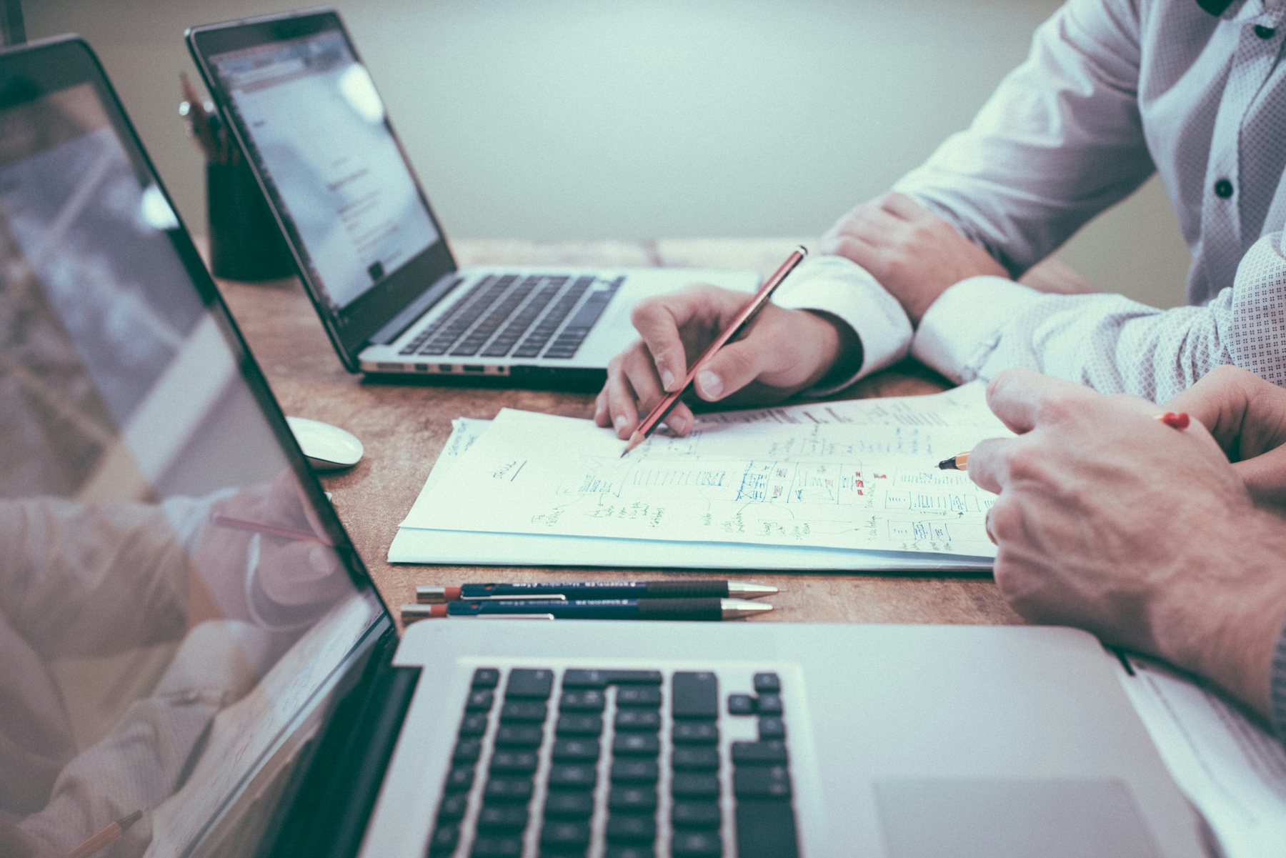 Professionals reviewing documents and charts at a table